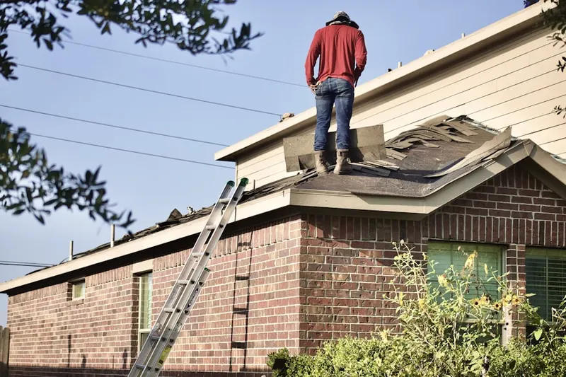 Professional roofer working on a residential roof in Hills of Park North